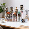A collection of natural crystal wishing bottles filled with various raw stones and featuring gold-colored metal accents.