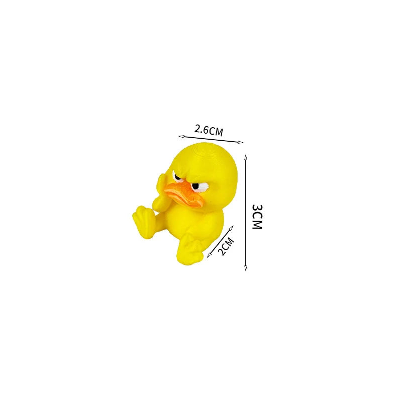 A yellow 3D printed figurine of an angry duck with orange beak and eyes.