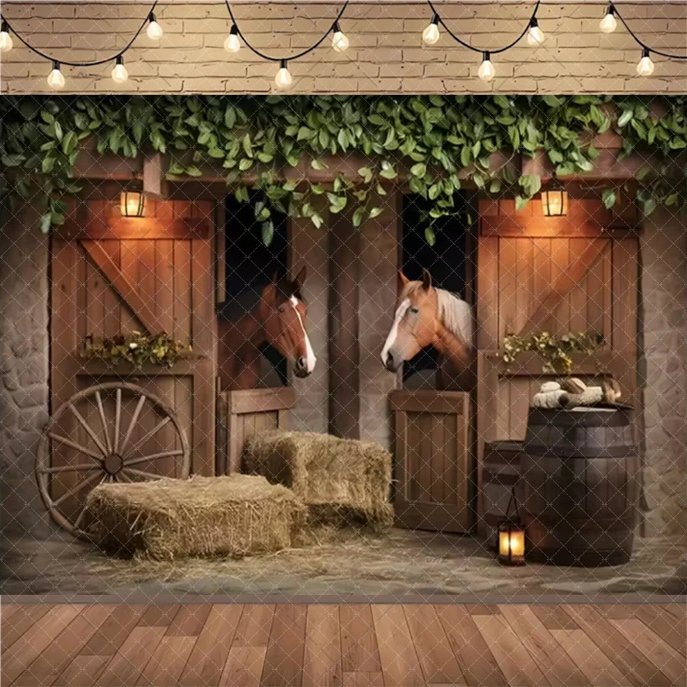 A rustic farm barn scene backdrop featuring wooden doors, greenery, and hay bales for a wild west birthday party.