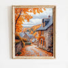 Oil painting of an autumn field landscape featuring stone buildings and vibrant orange foliage.