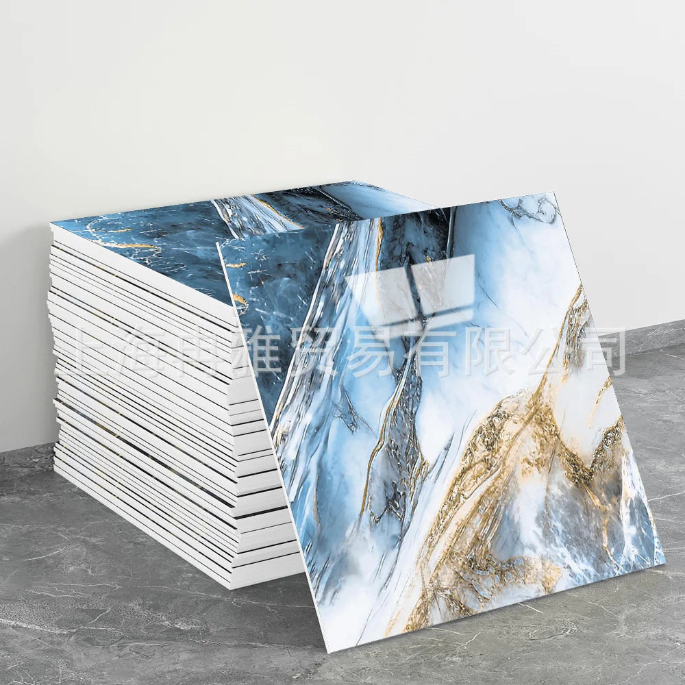 Stack of faux marble 3D self-adhesive wall tiles featuring blue and gold veining on a gray background