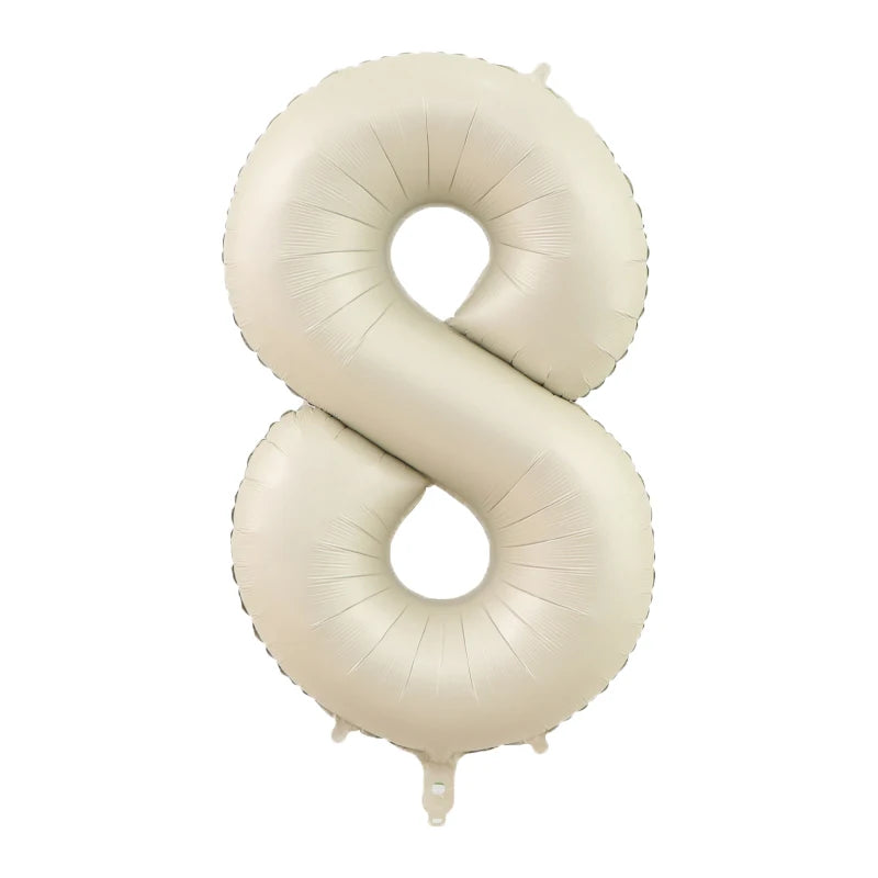 A large, beige foil number balloon shaped like the number eight.