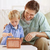 A man is showing a child a reusable wooden piggy bank for saving goals.