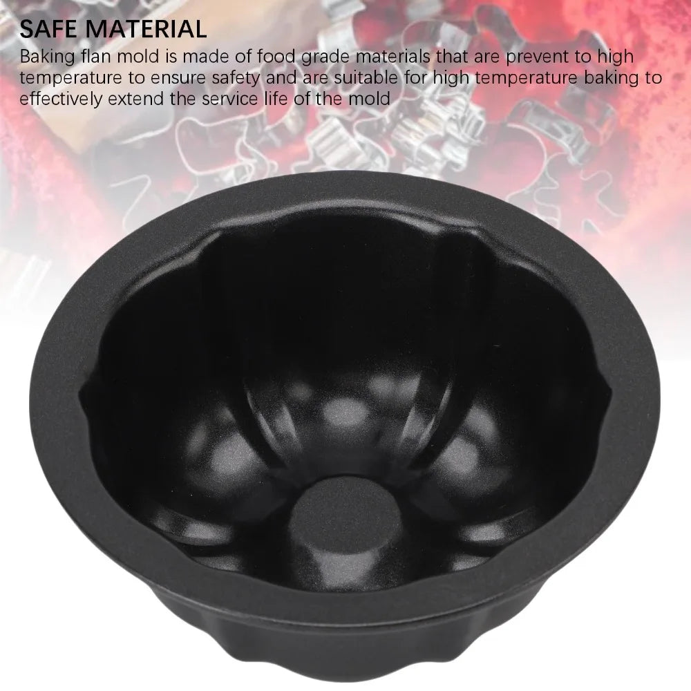 A black nonstick mini fluted cake pan is shown against a blurred red background.