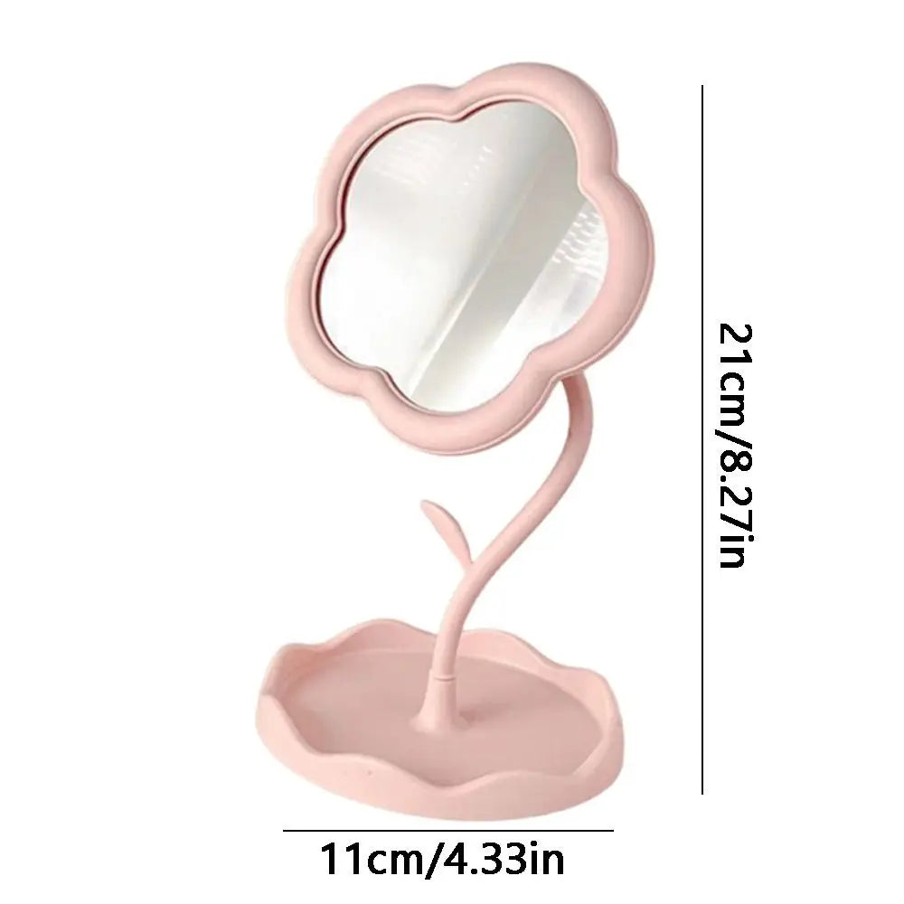 A pink sunflower heart dressing makeup mirror with a rounded frame and a flat base.