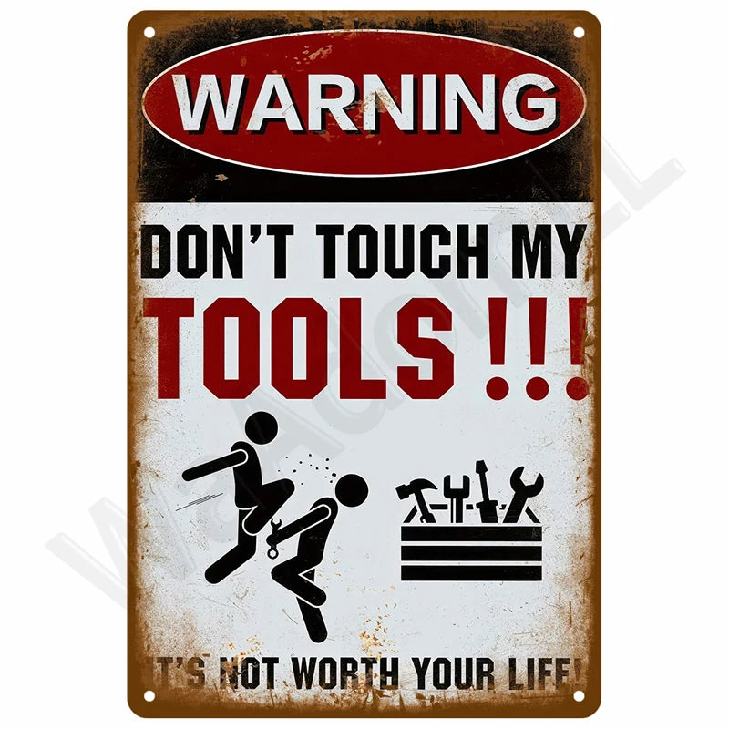 A vintage metal warning sign with red and white text advising not to touch tools.