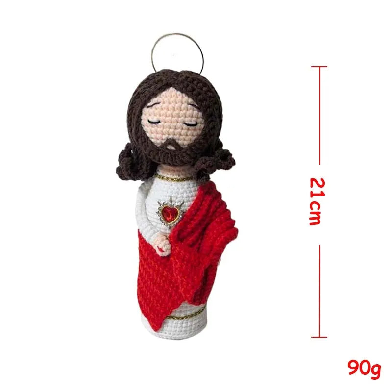 Handcrafted Virgin Mary crochet doll with dark hair and a red garment hanging from a loop.