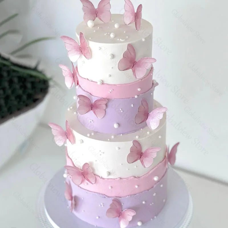 A three-tiered cake decorated with pink and purple buttercream and pink butterfly toppers.