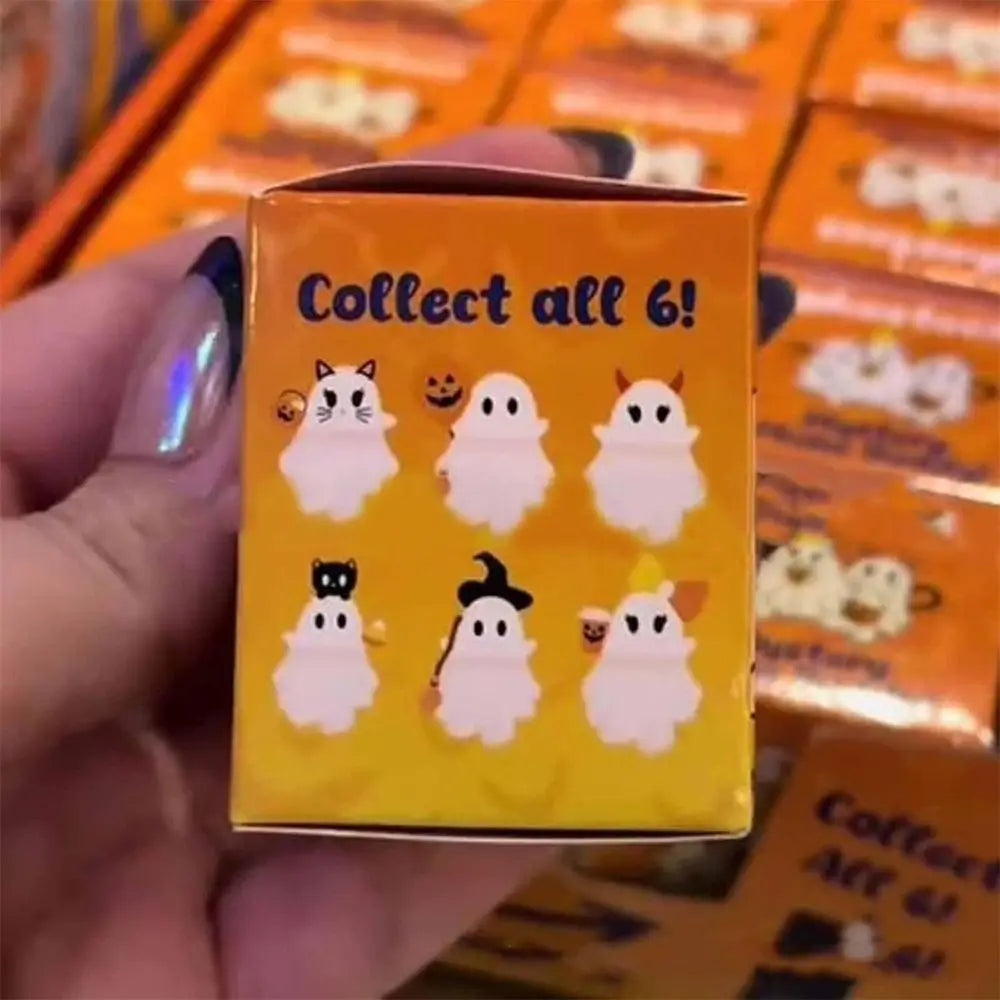 A hand holds a cardboard box of six peel-and-stick ghost phone decoration charms.