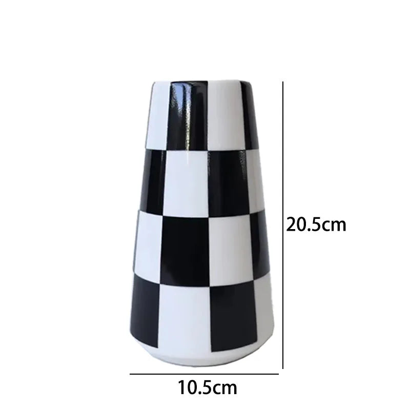 A tall ceramic tabletop vase with a black and white checkerboard pattern.