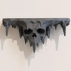 A dark, melted skull wall shelf with dripping features, displayed against a light background.