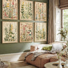 A set of three framed canvas prints depicting retro wildflower landscapes on a muted green wall.