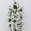 A cascading arrangement of white faux bougainvillea vine flowers against a white background.