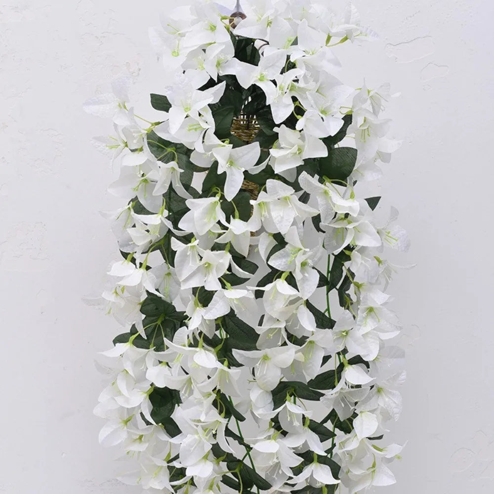 A cascading arrangement of white faux bougainvillea vine flowers against a white background.