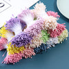 A colorful arrangement of mini artificial flower stamens in shades of pink, purple, yellow, and white.