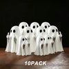 A pack of ten white ghost figurines with playful poses displayed on a dark surface.