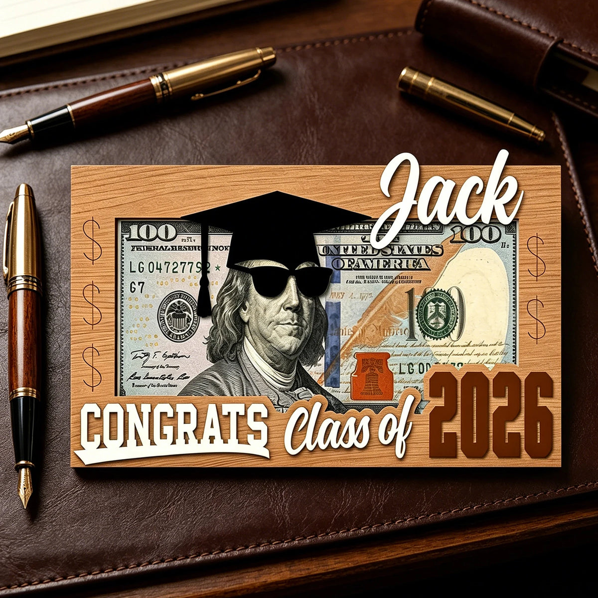 A wooden plaque featuring a portrait of Jack surrounded by US currency and the text Congrats Class of 2026