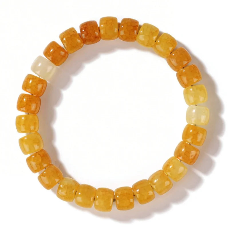 A bracelet made of small, round citrine crystals in shades of yellow and orange.
