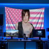 A banner featuring the American flag design displayed on a screen in a dark studio setting.