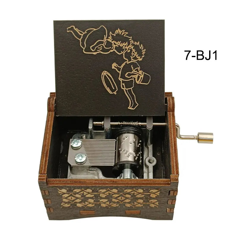 A wooden music box with a dark lid featuring an anime character silhouette and a brass key.