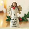 A white angel statue with gold wings holds a red heart and features the text A SISTER'S love is a special love that lasts for