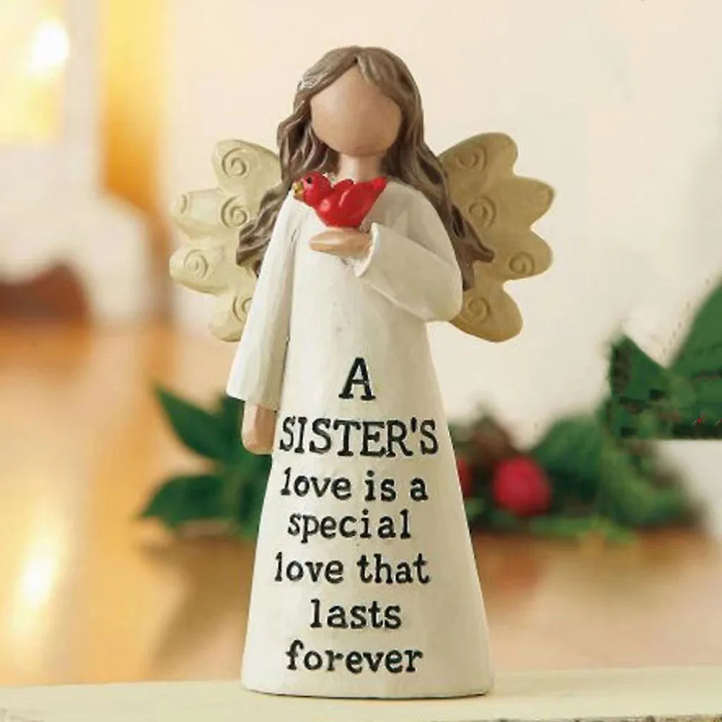 A white angel statue with gold wings holds a red heart and features the text A SISTER'S love is a special love that lasts for