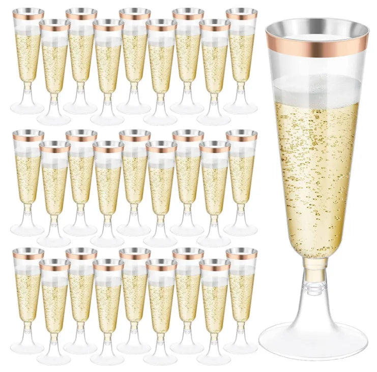 A collection of elegant disposable plastic champagne flutes in gold and clear glass, shown from various angles.