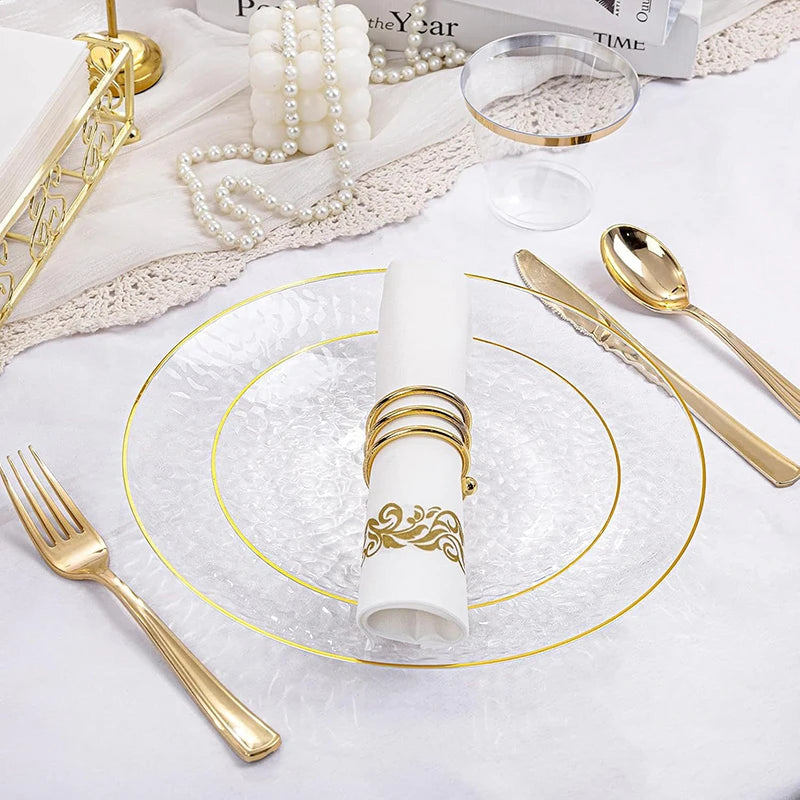 Hammered gold rim disposable dinner plates with a white napkin and pearl strands