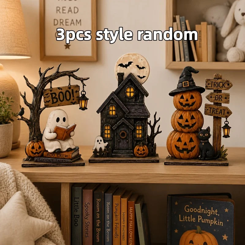 A set of three random style wooden Halloween block decor featuring a spooky tree, a haunted house, and a jack-o'-lantern.