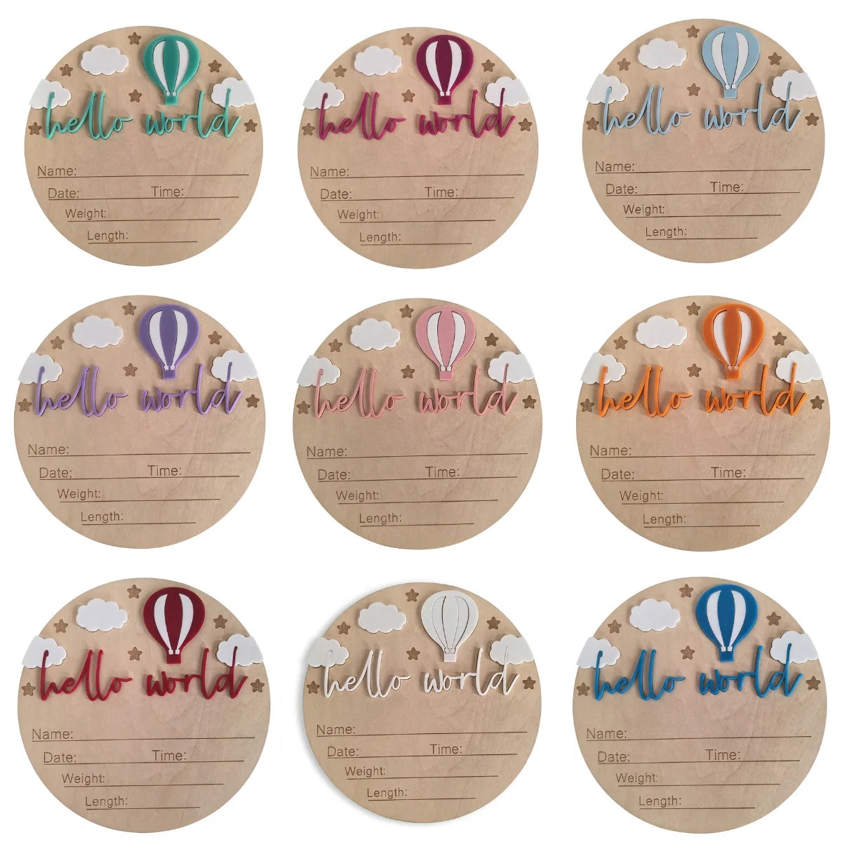 A set of six round wooden plaques with watercolor illustrations of hot air balloons and text for birth announcements.