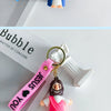 A silicone keychain featuring a Jesus figure and a pink strap with a heart design.