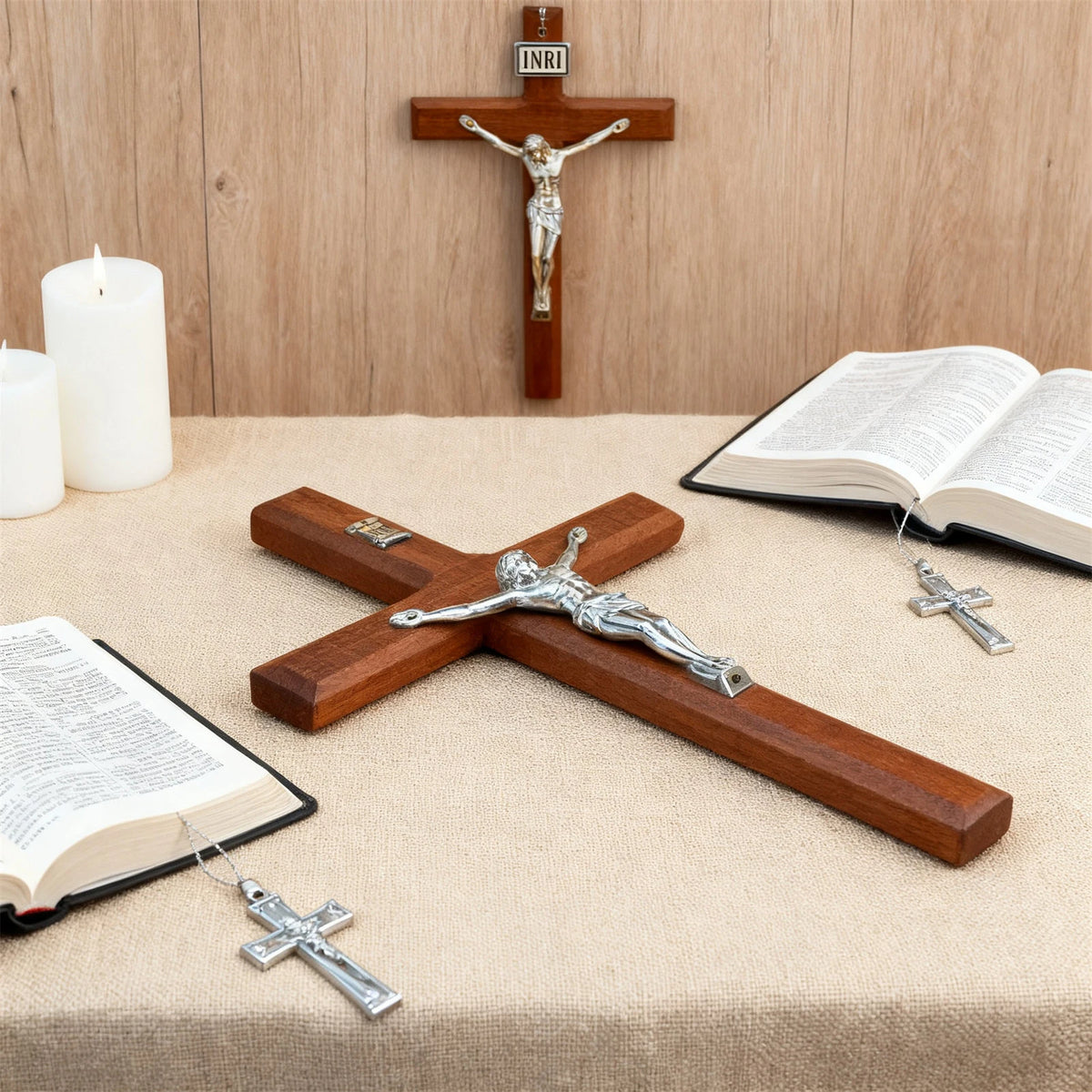 A hand-carved wooden cross wall decor with a silver crucifix and a larger wooden cross displayed on a table.