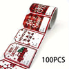 A roll of Christmas present stickers featuring holiday phrases like Let It Snow and Merry Christmas