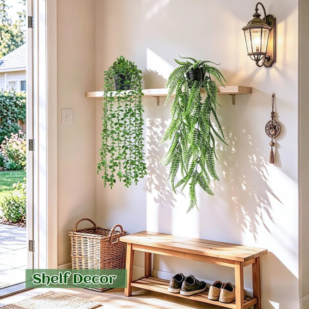Four realistic hanging artificial ivy vines in various shades of green displayed on a white wall.