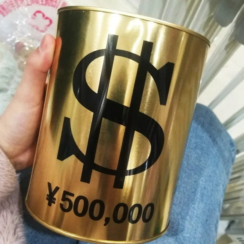 A close-up of a gold-colored metal piggy bank with a large black dollar sign and the text ¥500,000 printed on it.