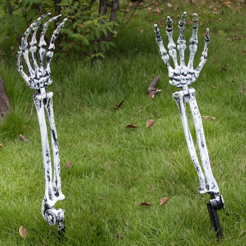 Two white realistic skeleton arm stakes used for Halloween lawn decor