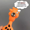 An orange cartoon giraffe shaped fridge magnet with a silver button detail.