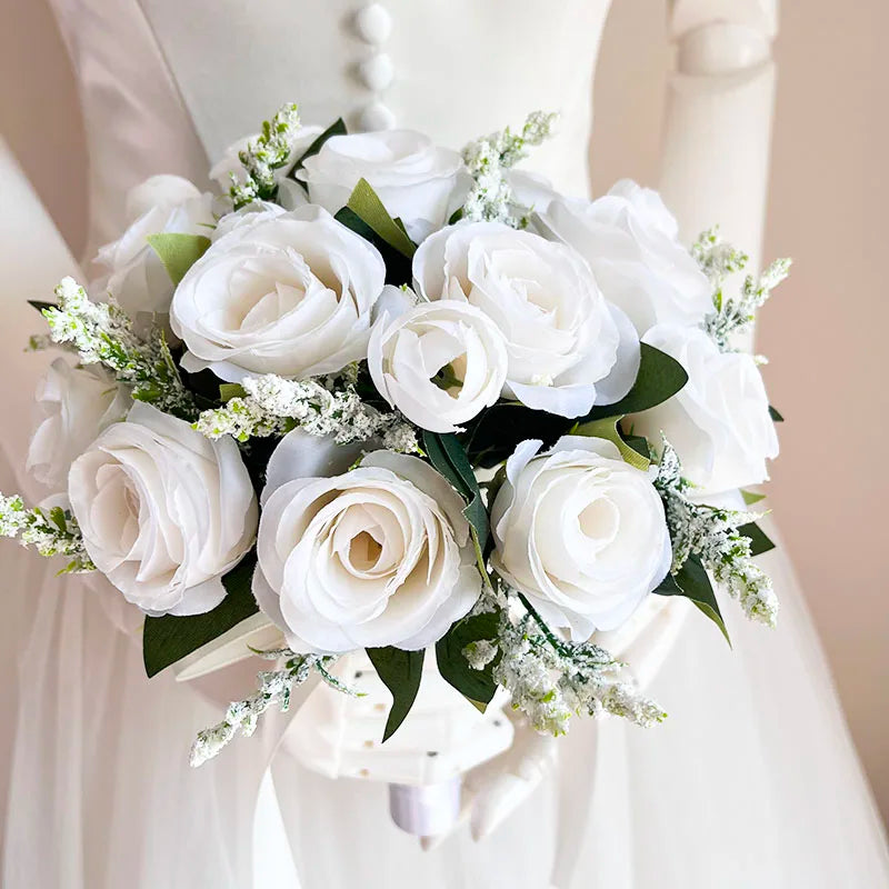A white silk rose bridal bouquet featuring soft, creamy roses and delicate white filler flowers.