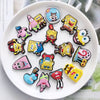 A collection of colorful SpongeBob SquarePants themed shoe charms and pins arranged on a white plate.