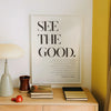 A framed canvas wall art poster with black text on a white background that reads See the Good.
