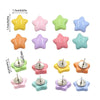 A set of decorative pentagram thumb tacks in various pastel colors including yellow, pink, green, and blue.