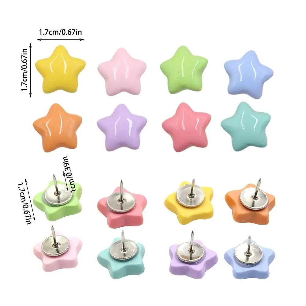 A set of decorative pentagram thumb tacks in various pastel colors including yellow, pink, green, and blue.