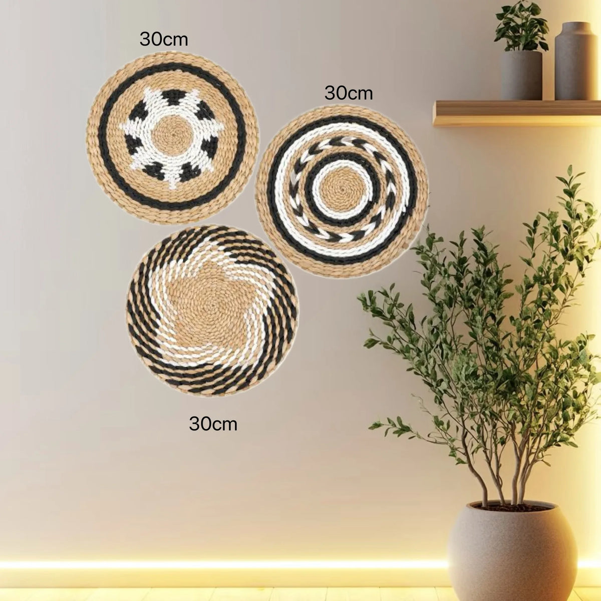 Three round boho straw wall hangings with woven tassels displayed on a light-colored wall.