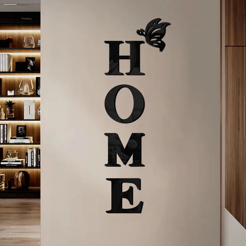 Black butterfly letter wall mirror decals spelling out HOME on a light beige wall.