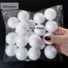 A hand holds a clear plastic bag filled with 20 white polystyrene foam balls for crafting.