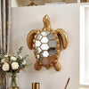 Golden sea turtle resin wall decor mirror mounted on a white wall