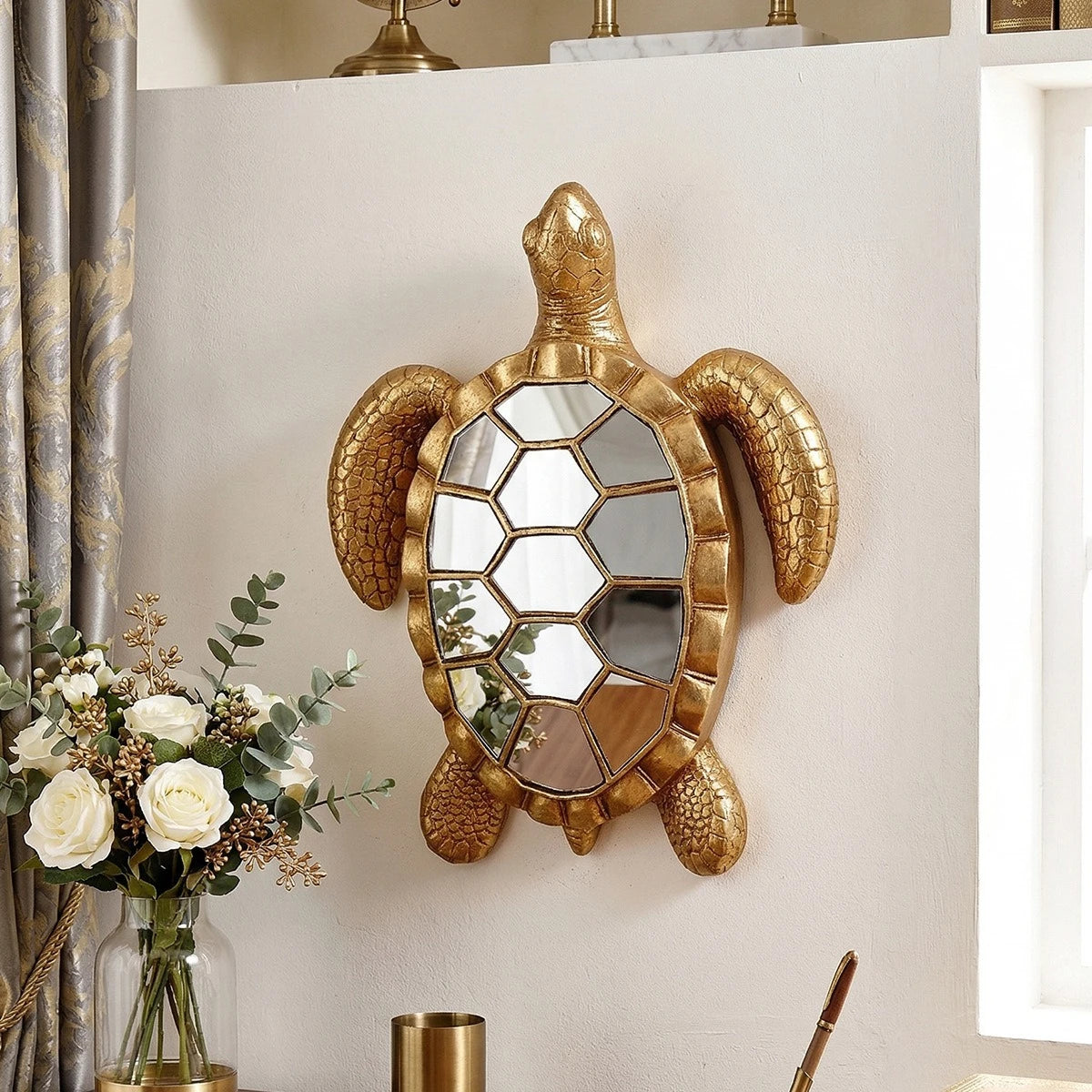 Golden sea turtle resin wall decor mirror mounted on a white wall