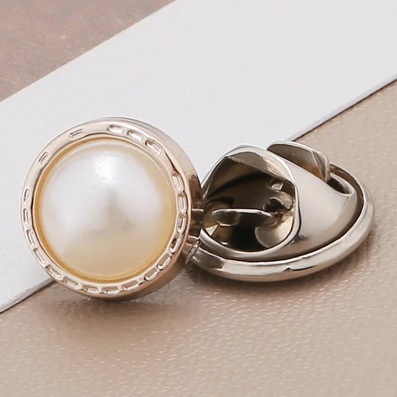 Silver pearl and rhinestone no-sew brooch buttons displayed on a white card.