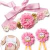 Pink floral maternity sash and corsage pin set with a bow for a baby shower