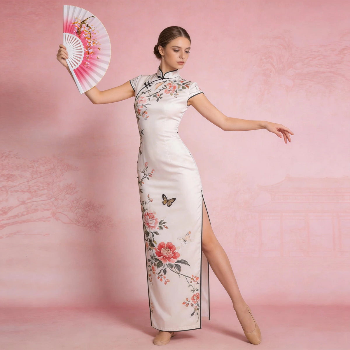 A woman models a white floral print dress and a pink folding fan against a pink background.